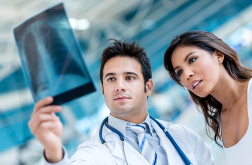 Male doctor looking an x-ray  with a patient