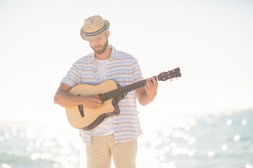 Musician playing guitar on the beach-1